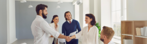 HR recruiter shaking hands with newly hired candidate